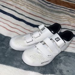 White Bontrager Vella cycling shoes with velcro straps.