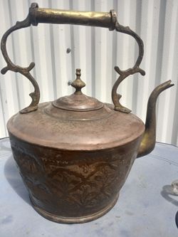 AI Overview        This item is an antique Middle Eastern copper and brass tea pot