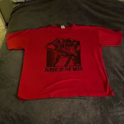 red graphic t-shirt with "PLAYER OF THE WEEK" text and a graphic design