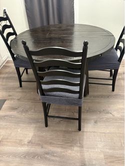 5ft solid wood table. 3 chairs with new cushions and cushion covers