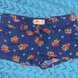 blue Hollister floral print shorts with a button and zipper closure