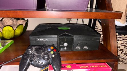 Original Xbox — tested and working, includes power cable, AV cable, and 2 controllers also comes with 2-3 games that I have of your  choice