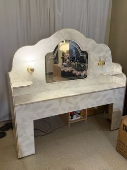 Vintage white headboard with mirror and built-in lamps.