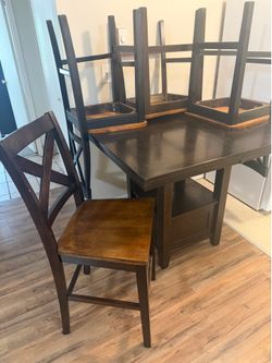 Ashley Hayley 5-piece counter height table set featuring a dark brown wood finish