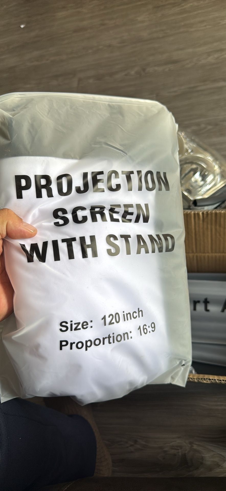 120-inch projection screen that comes with a stand.