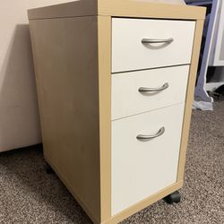 light wood color cabinet with 3 draws