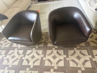 Two leather brown spinning chairs