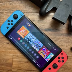 Nintendo Switch With Charger And A Couple More Things