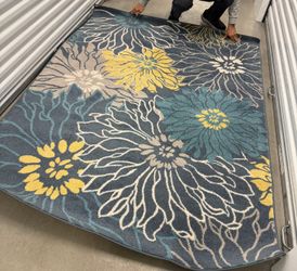 Three sets of blue and yellow flower rugs