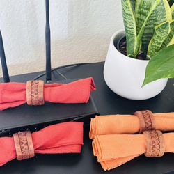 carved wooden napkin rings with orange and red cloth napkins