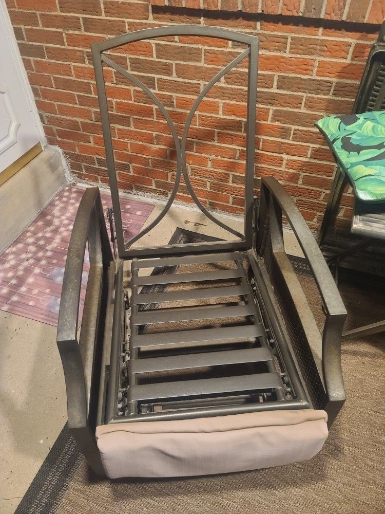 two metal outdoor recliners, no cushions