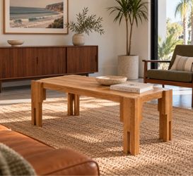 Beautiful solid wood MCM coffee table with a warm, natural finish and unique architectural legs.