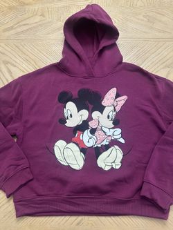 Disney Mickey and Minnie Mouse graphic pullover hoodie sweatshirt in a purple or burgundy color, made from a cotton/polyester blend material. 