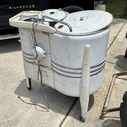 Vintage 1940s or 1950s. It is a combination washer and spin dryer. 