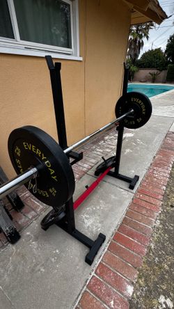 Squat and bench press rack with 4x 35 LB plates - adjustable.