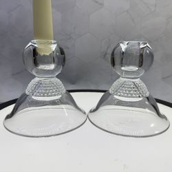 Set of (2) vintage Duncan & Miller Teardrop Clear single light candle holders made of pressed glass. They feature a distinct beaded stem design, often