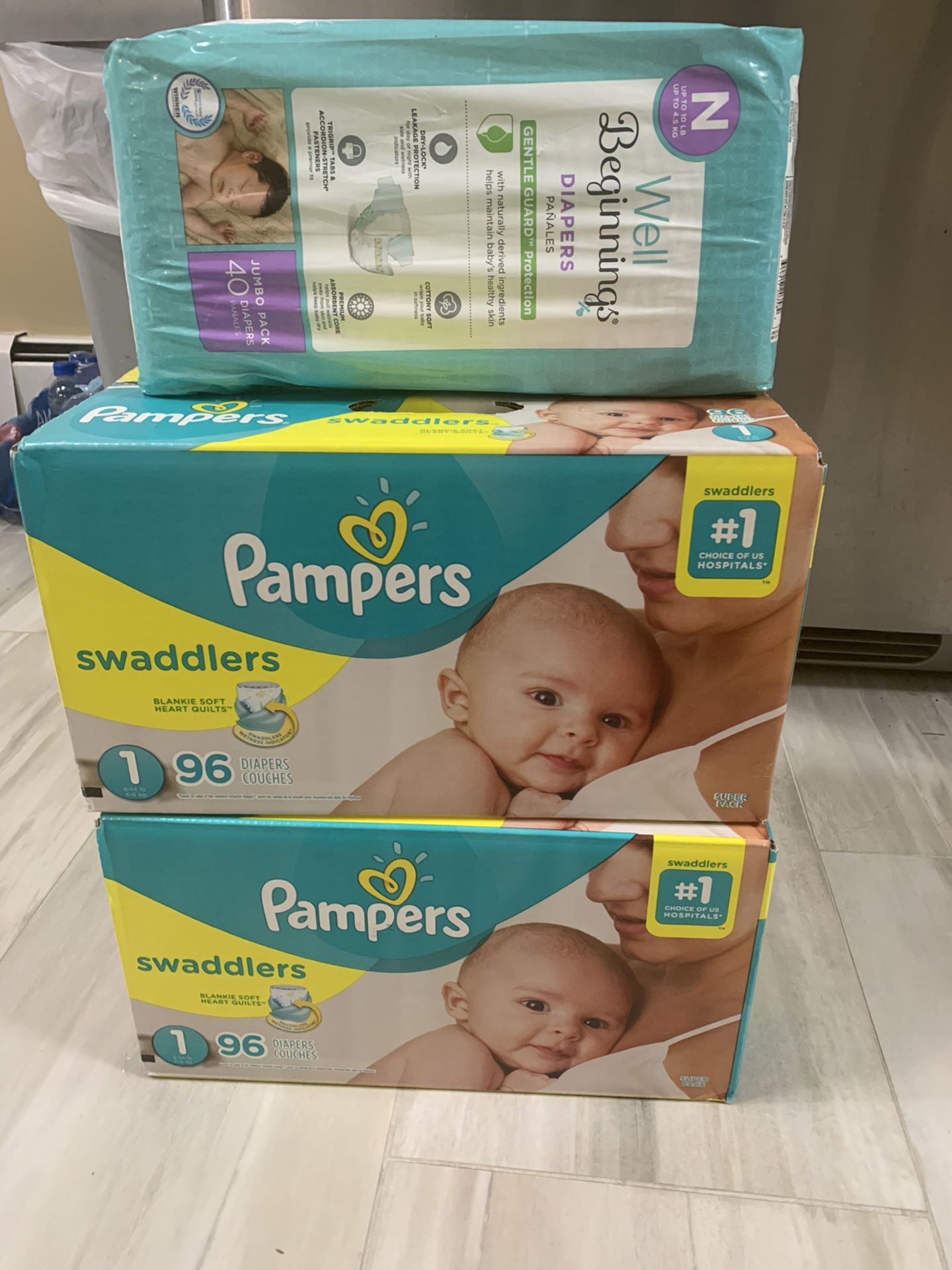 Size 1 pampers and one pack newborn diapers