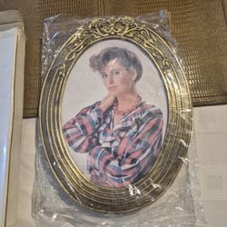 Brand new 9 inch by 7 inch. Oval metal frame