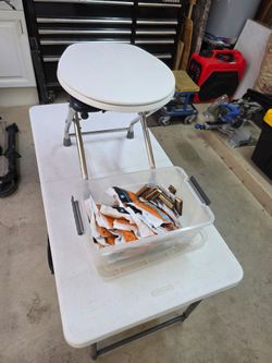 Folding camp toilet with supply of Wag Bag