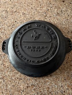 John Wayne Cast Iron Pie Pan featuring the embossed text "JOHN WAYNE AUTHENTIC CAST IRON"