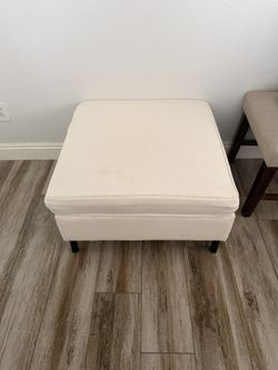 Three off-white Ottomans