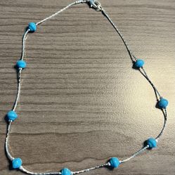 Lightweight turquoise blue beaded necklace with a delicate silver-tone chain. Simple, versatile design that adds a pop of color to any outfit. Comfort