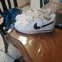 white and black Nike Cortez sneakers. 
