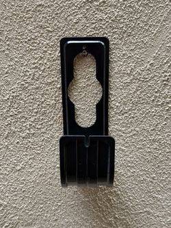 Plastic wall-mounted hose holder