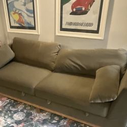 GREEN SOFA WITH STORAGE COMPARTMENTS UNDER CUSHIONS