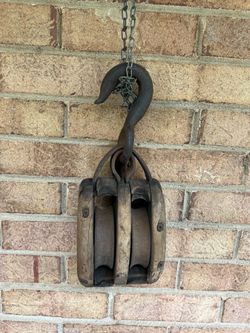 Antique double pulley block and tackle with forged hook.