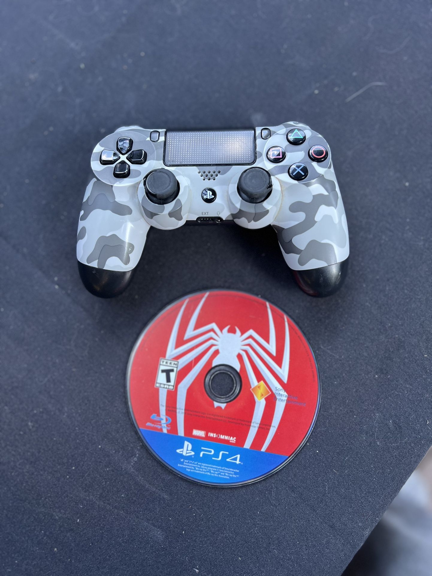 PlayStation 4 controller and Spider-Man game