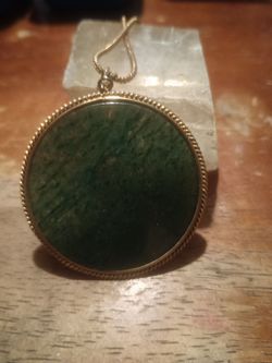 Mid 20th century genuine jade disk set in twisted rope design for sale.