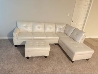 Cream sectional and ottoman for sale, new condition.