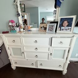 Dresser with mirror, chest, and two night stands.
