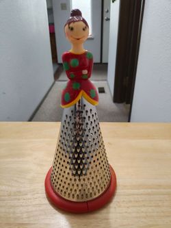 Unique grater. Looks like a doll. Four different grates