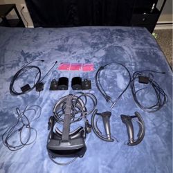 Valve index VR headset with controllers, cables, and base stations.