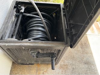 Used Sunset Track hose holder with 50 ft hose ( Handle has taped ).