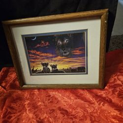 framed art piece titled "Two Mothers" by wildlife artist Schim Schimmel, depicting a lion family. 