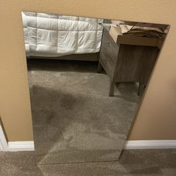 22”W by 38” H frameless round clear mirror. 