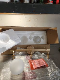 3-light modern gold or brass bathroom vanity light fixture with frosted globe shades