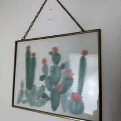 framed cactus wall art in a brass-tone metal frame