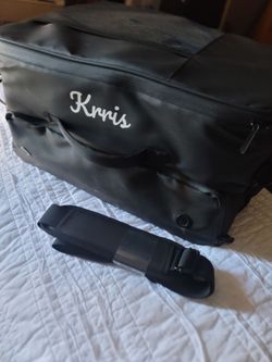 Krris Golf Trunk Organizer, a two-layer black nylon storage bag designed to hold shoes, golf balls, apparel, and accessories in your car trunk