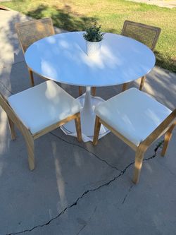 White tulip dining table and 4 rattan chairs included
