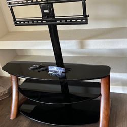 Sturdy wooden and glass TV stand console with built in mount