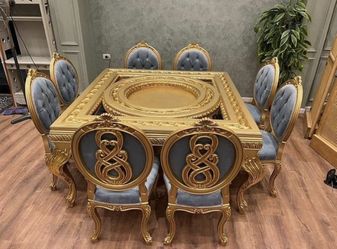 Luxury Dining Set LOOK UP A contemporary gilded dining table with eight upholstered chairs. TIME PERIOD 21st Century ORIGIN Contemporary Luxury ESTIMA