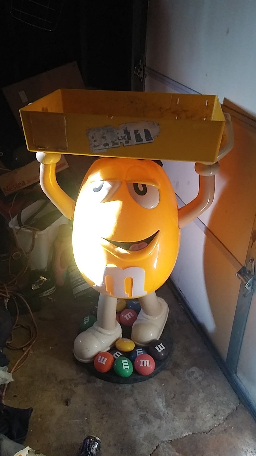 Plastic yellow M&M statue Trey carrier