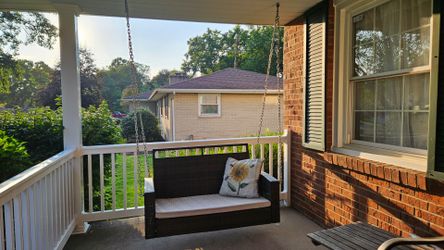 Slightly used porch swing with cushion