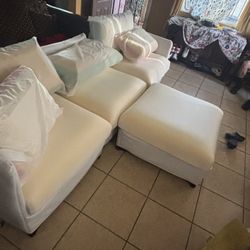 stylish sectional couch with a matching ottoman.