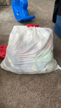 Bag full of baby girl clothes and toys