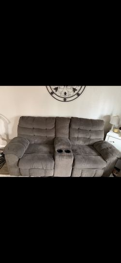 Grey love seats and dual recliners with center console